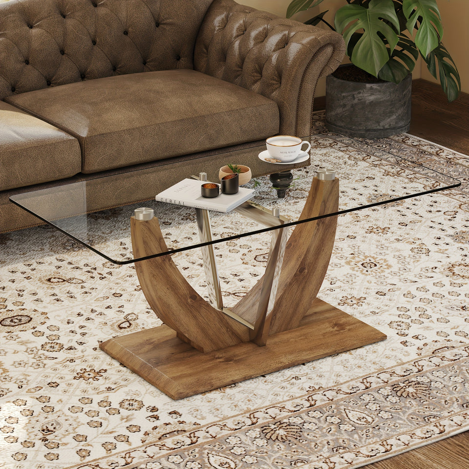Modern minimalist transparent tempered glass coffee table with wooden legs and stainless steel decorative columns. Computer desk. Game table.
